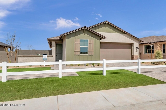 view of front facade with a garage and a front lawn