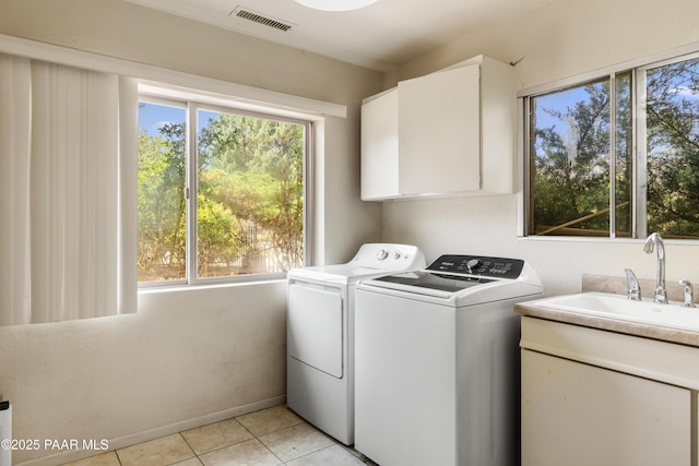 707 Apache Dr, Dewey-Humboldt, AZ 86327 - washroom with washing machine and clothes dryer, cabinet space, healthy amount of natural light, and light tile patterned floors