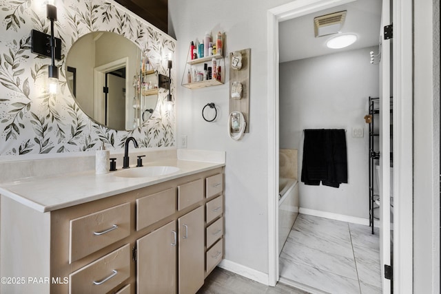 707 Apache Dr, Dewey-Humboldt, AZ 86327 - bathroom with vanity, a tub to relax in, baseboards, and marble look tiles