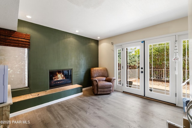707 Apache Dr, Dewey-Humboldt, AZ 86327 - sitting room with a glass covered fireplace, wood finished floors, french doors, and recessed lighting