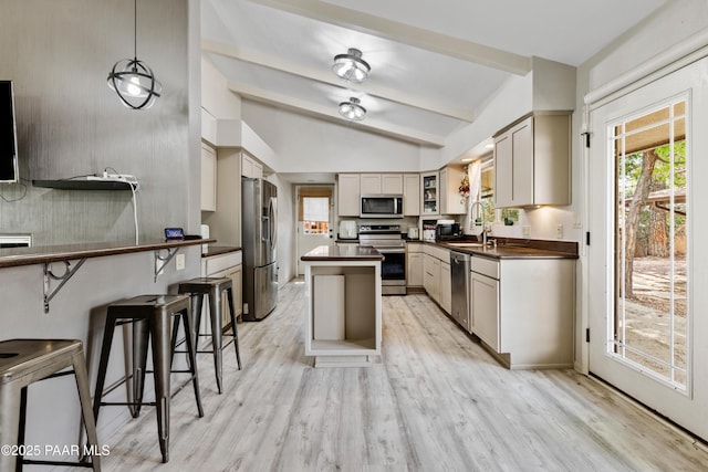 707 Apache Dr, Dewey-Humboldt, AZ 86327 - kitchen featuring appliances with stainless steel finishes, dark countertops, light wood-type flooring, a center island, and a sink