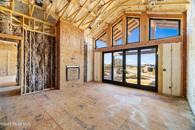 interior space featuring high vaulted ceiling and french doors