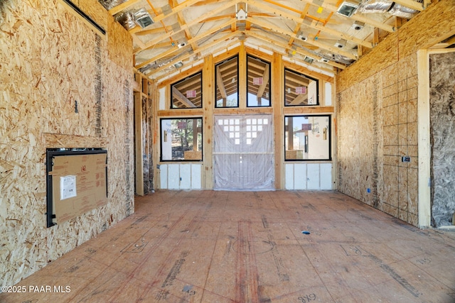 unfurnished living room featuring lofted ceiling