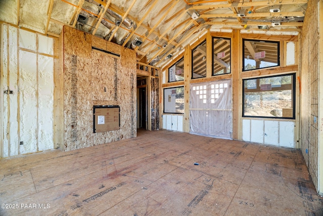 unfurnished living room with vaulted ceiling