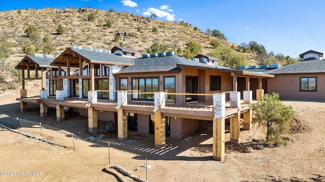 rear view of property with a deck with mountain view