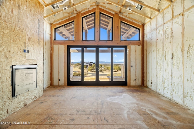 interior space featuring high vaulted ceiling and french doors