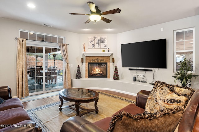 930 S Kerasi Ct, Dewey-Humboldt, AZ 86327 - living area with ceiling fan, wood finished floors, and a lit fireplace