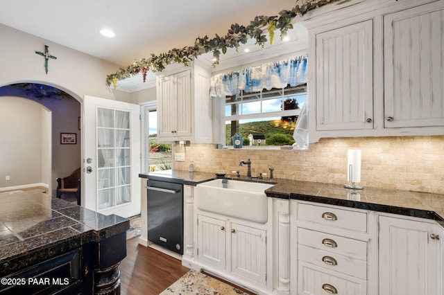 930 S Kerasi Ct, Dewey-Humboldt, AZ 86327 - kitchen with tile counters, dishwasher, a sink, arched walkways, and decorative backsplash