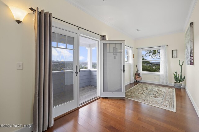 entryway with french doors, ornamental molding, wood finished floors, and baseboards