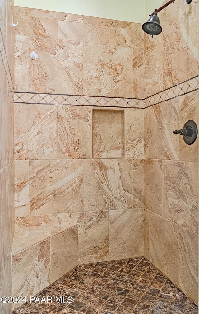 interior details featuring tiled shower