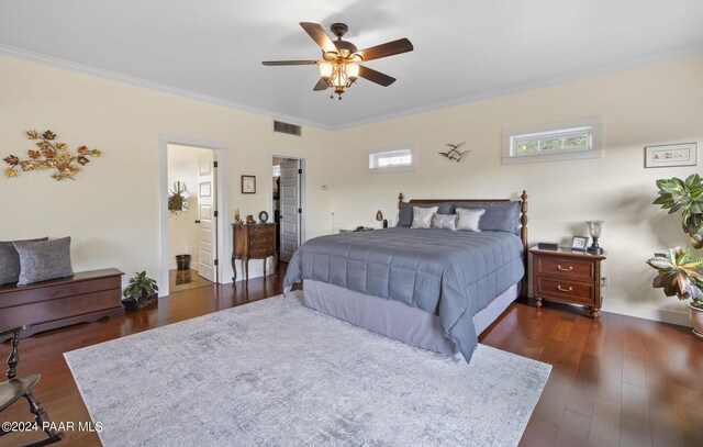 bedroom featuring dark wood-style floors, ornamental molding, and visible vents