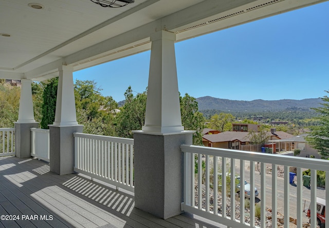 wooden deck featuring a residential view and a mountain view