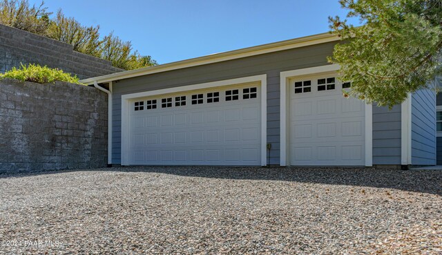 detached garage featuring fence