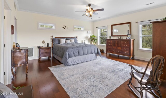 bedroom with baseboards, visible vents, dark wood-type flooring, and ornamental molding