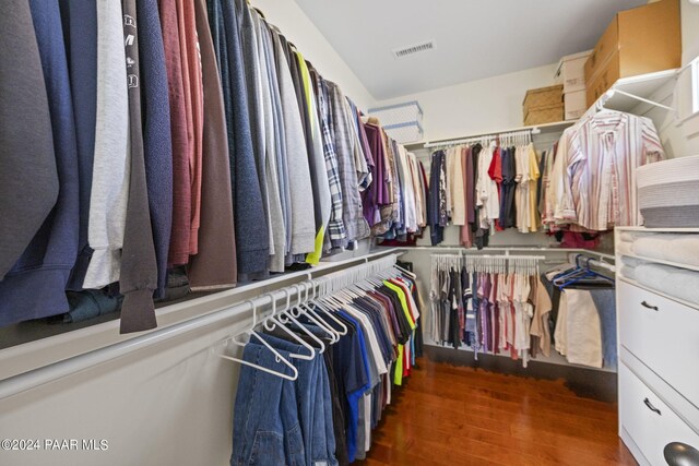 walk in closet with visible vents and dark wood finished floors