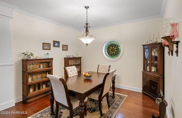 dining room with crown molding, baseboards, and dark wood-type flooring