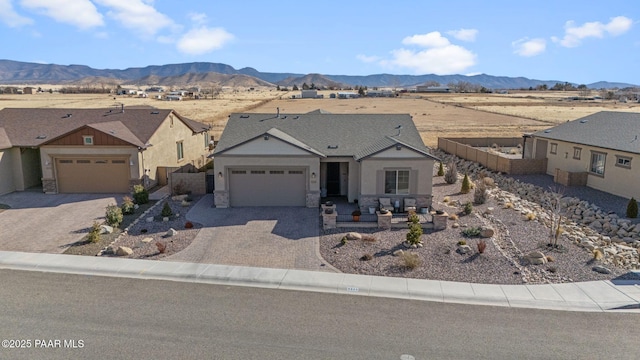 single story home featuring a mountain view and a garage