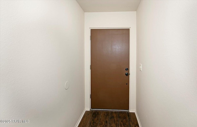 doorway to outside with dark wood-type flooring