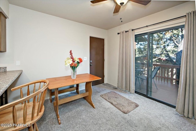 dining area featuring ceiling fan and carpet