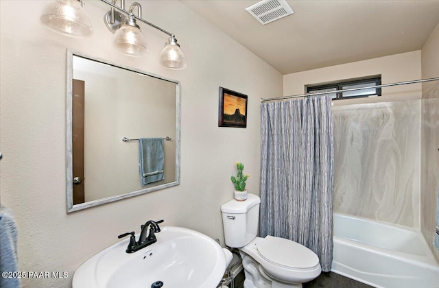 full bathroom featuring sink, toilet, and shower / tub combo with curtain