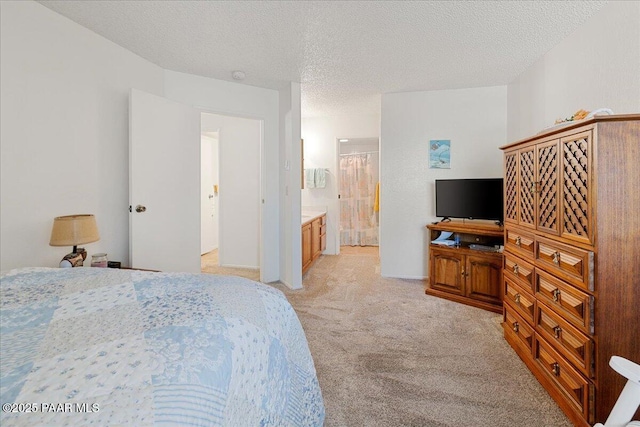 333 W Leroux St Unit D4, Prescott, AZ 86303 - bedroom featuring light carpet, a textured ceiling, and ensuite bathroom