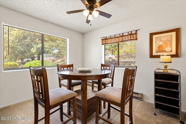 333 W Leroux St Unit D4, Prescott, AZ 86303 - dining room with a textured ceiling, ceiling fan, light colored carpet, a baseboard radiator, and plenty of natural light
