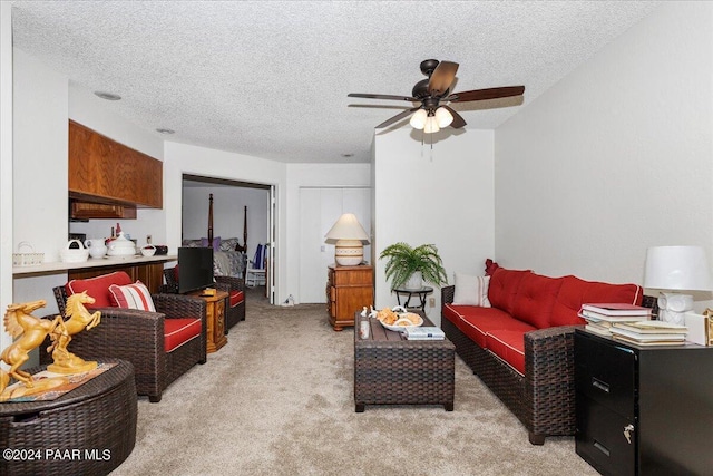 carpeted living room featuring a textured ceiling and ceiling fan