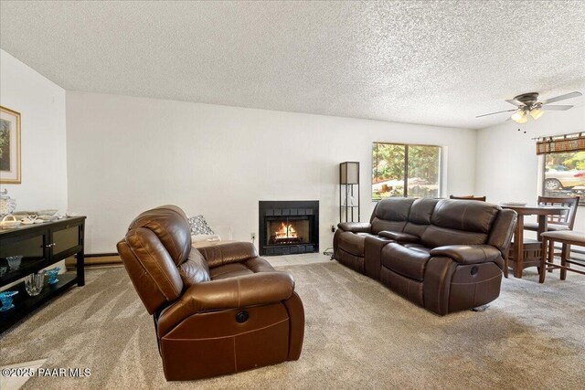 333 W Leroux St Unit D4, Prescott, AZ 86303 - carpeted living area with ceiling fan, a textured ceiling, and a fireplace with flush hearth
