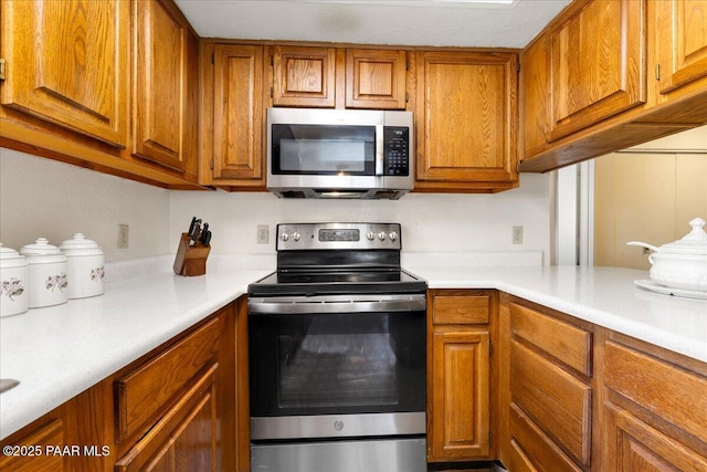333 W Leroux St Unit D4, Prescott, AZ 86303 - kitchen featuring stainless steel appliances, brown cabinets, and light countertops