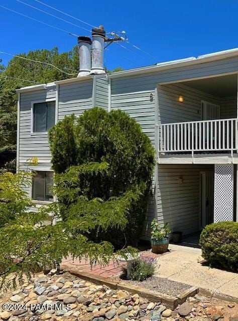 view of home's exterior with a balcony