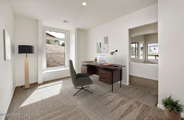 office area with visible vents, baseboards, plenty of natural light, and carpet flooring