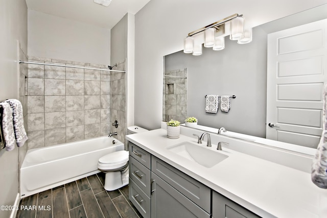 full bathroom featuring vanity, toilet, and tiled shower / bath