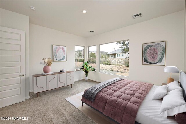 bedroom with light carpet, recessed lighting, visible vents, and baseboards