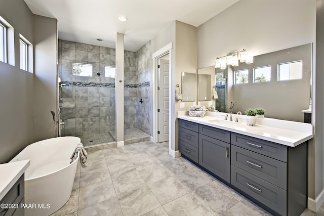 bathroom featuring shower with separate bathtub, vanity, and a wealth of natural light