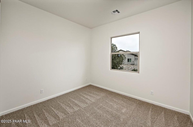 carpeted spare room with visible vents and baseboards