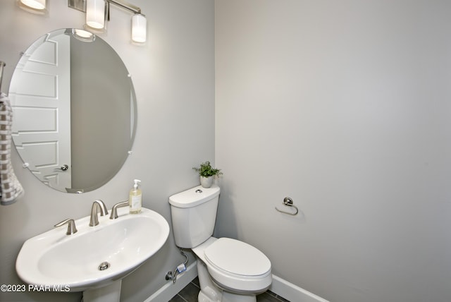 bathroom with tile patterned floors, sink, and toilet