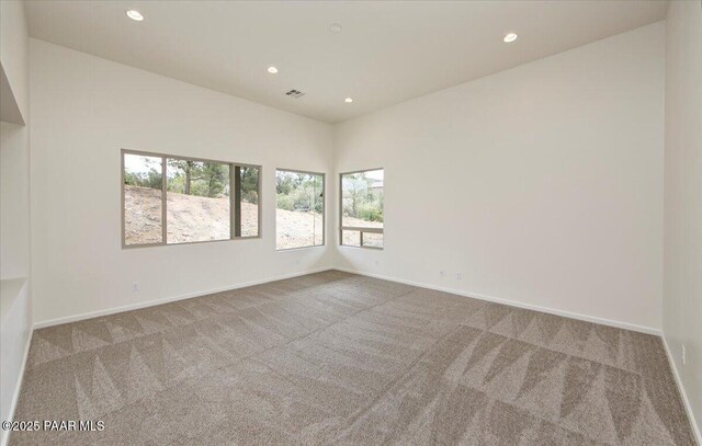 unfurnished room featuring baseboards, recessed lighting, and carpet flooring