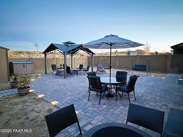 view of patio / terrace with a gazebo and a storage unit