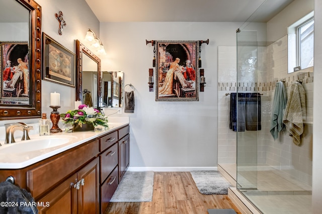 bathroom featuring a shower with door, vanity, and wood-type flooring