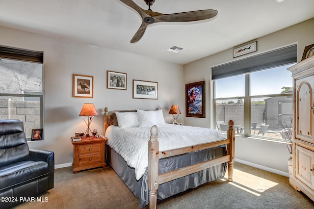 bedroom with ceiling fan and light carpet