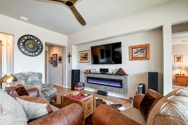 living room with hardwood / wood-style flooring and ceiling fan