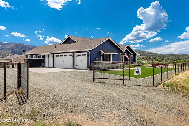 view of front facade featuring a mountain view and a garage