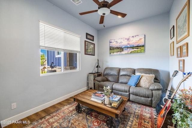 living room featuring ceiling fan and wood-type flooring