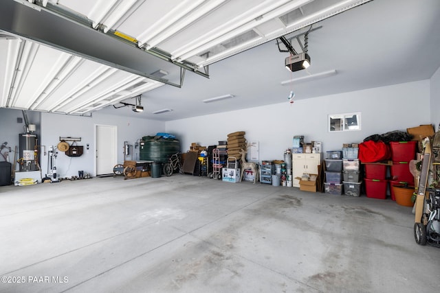 garage with water heater and a garage door opener