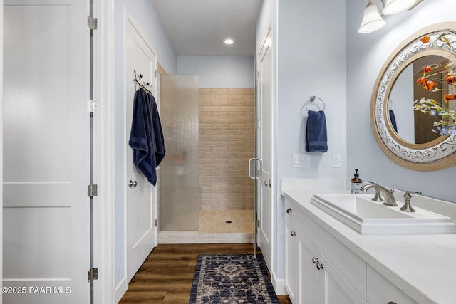 bathroom featuring vanity, a shower with shower door, and hardwood / wood-style flooring