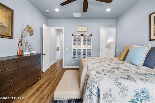 bedroom with ceiling fan, dark wood-type flooring, and ensuite bathroom