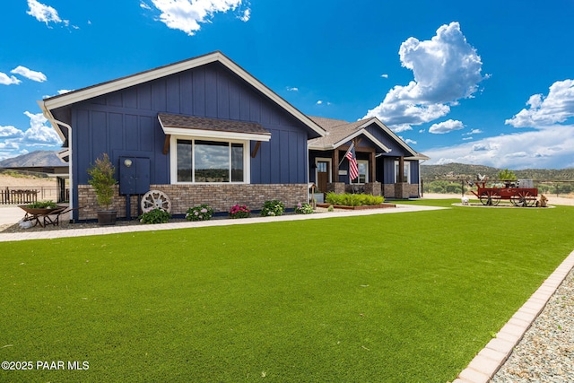 view of front of property featuring a mountain view and a front lawn