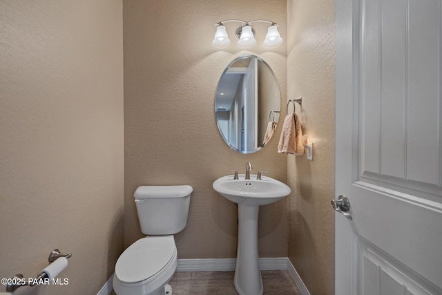 5486 N Jarvis Ct, Prescott Valley, AZ 86314 - half bathroom with toilet, baseboards, and a sink