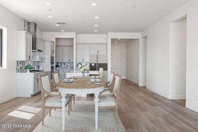 dining area with recessed lighting, light wood-type flooring, visible vents, and baseboards