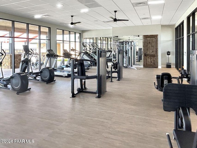 workout area with visible vents, ceiling fan, wood finished floors, a drop ceiling, and baseboards